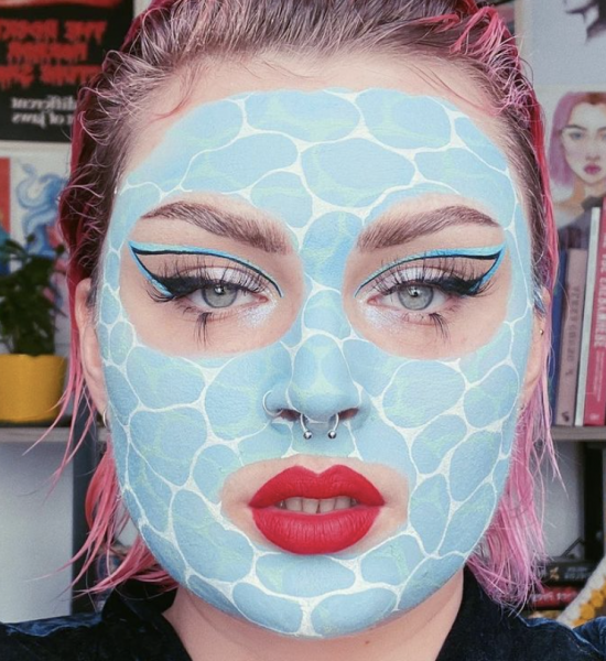 Portrait of a person wearing blue and white makeup