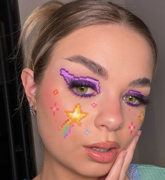 Portrait of a woman wearing winged eyeliner and stars on face