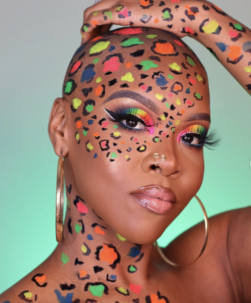 Portrait of woman wearing green orange pink blue and yellow makeup