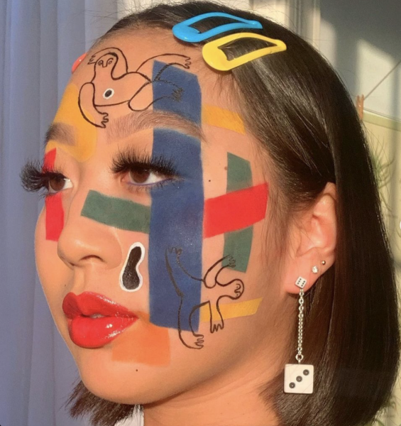 Portrait of a woman wearing illustrations on her face.