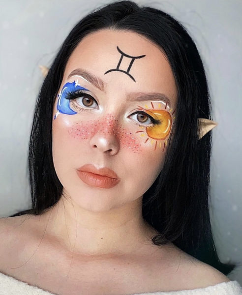 Portrait of a woman wearing astrological signs on face
