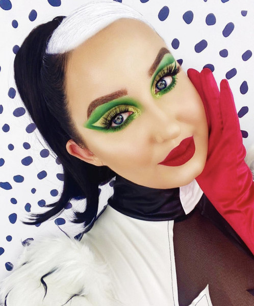 Portrait of woman wearing green eye makeup with a red lip