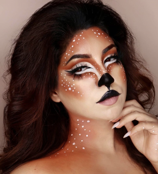 Portrait of a woman wearing makeup that resembles a deer.